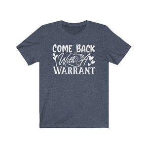Peut inclure: Un t-shirt bleu fonc&eacute; avec le texte "Come Back With A Warrant" en lettres blanches.