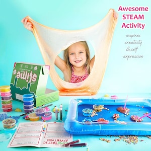 May include: A young girl smiles through a stretched, translucent orange slime. The image showcases a DIY slime kit with various colorful components, including glitter, beads, and containers. Text reads "Awesome STEAM Activity" and "DIY slime kit".