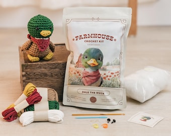 May include: A farmhouse crochet kit featuring a cartoon duck named Dale. The kit includes yarn, needles, and instructions for beginners. The kit also includes a stuffed duck amigurumi.