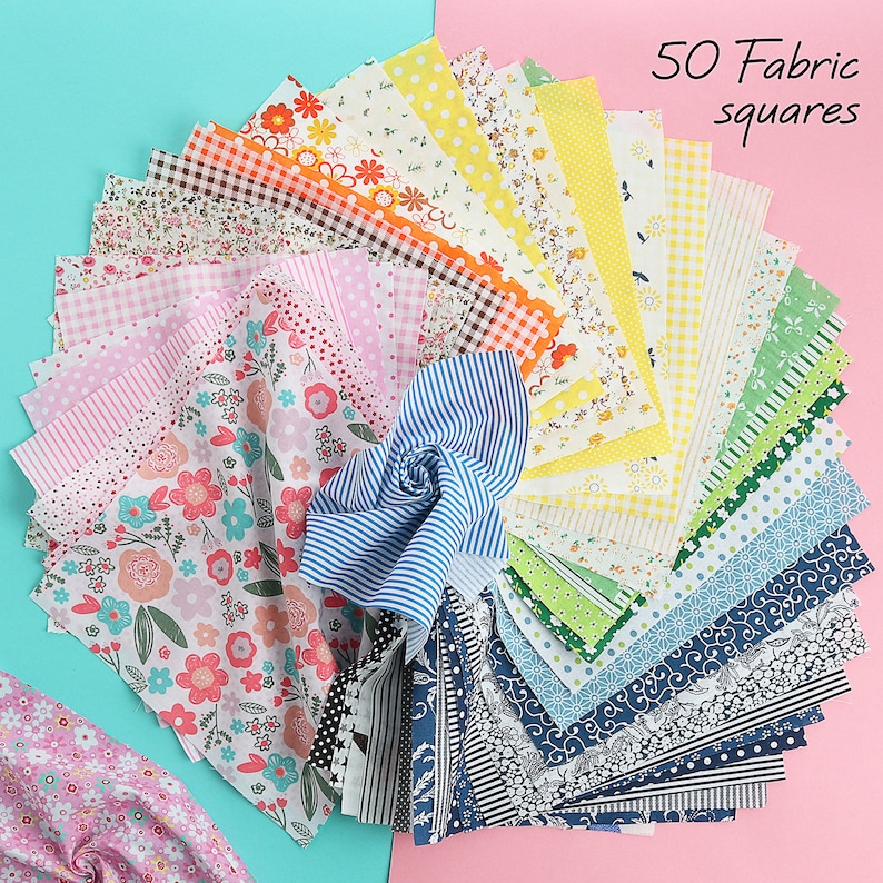 May include: A collection of 50 fabric squares in various colors and patterns, including floral, polka dot, striped, and checkered designs. The squares are arranged in a fan shape on a pink and blue background.