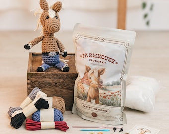 May include: Crochet kit for beginners featuring a brown and white horse named Harvey. The kit includes yarn, stuffing, needles, and safety eyes. The kit is packaged in a white bag with the text "Farmhouse Crochet Kit for Beginners" and a picture of a brown and white horse.