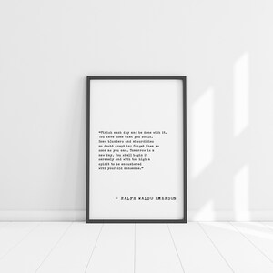 May include: A framed print with a black border, featuring a quote by Ralph Waldo Emerson in a classic font. The quote is centered on a white background, offering a minimalist and inspirational aesthetic. The print is displayed against a white wall.