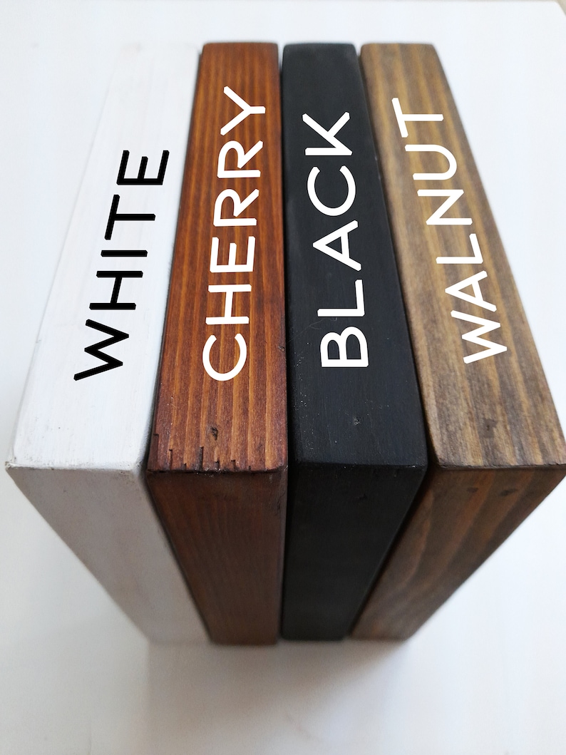 May include: Four wooden blocks in white, cherry, black, and walnut colors. Each block has a different color and the name of the color is printed in white on the side of each block. The blocks are arranged side by side.