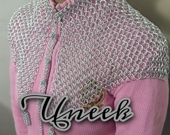 May include: A silver chainmail collar with a decorative chain hanging from the front. The collar is worn over a pink sweater.