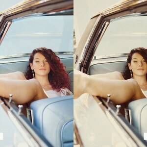 May include: A woman with long, curly red hair sits in the backseat of a vintage car. She is wearing a white dress and has her legs up on the dashboard. The car is a light blue color and has a chrome trim.