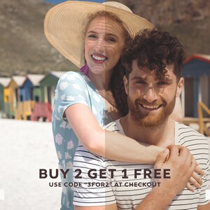 May include: A couple smiles for the camera on a beach with colorful beach huts in the background. The woman is wearing a straw hat and a light blue floral print shirt. The man is wearing a striped shirt. The text "BUY 2 GET 1 FREE USE CODE "3FOR2" AT CHECKOUT" is displayed below the couple.