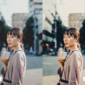 May include: A woman in a light brown jacket is drinking from a clear plastic cup with a straw. She is standing in a city street with buildings in the background.