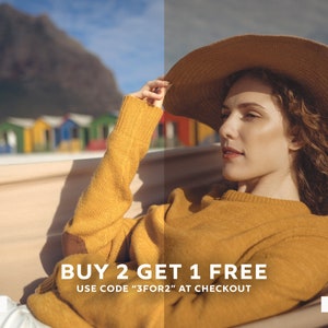 May include: A woman wearing a yellow sweater and a wide-brimmed hat relaxes in a hammock. The background features colorful houses and a mountain. The text "BUY 2 GET 1 FREE" and "USE CODE "3FOR2" AT CHECKOUT" is displayed below the image.