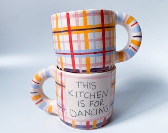 Handmade Striped Ceramic Coffee Mug: 'This Kitchen is for Dancing'