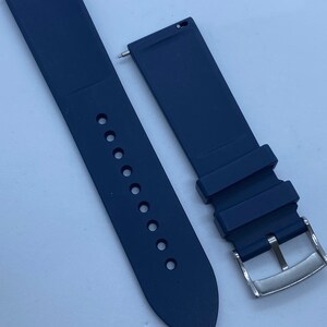 May include: A pair of dark blue silicone watch straps with a silver buckle. The straps are designed for a watch with a 22mm lug width.
