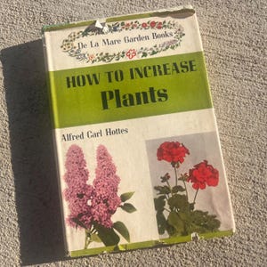 May include: Vintage gardening book titled "How to Increase Plants" by Alfred Carl Hottes. The cover features a green band with the title, floral illustrations, and images of pink and red flowers. "De La Mare Garden Books" is printed at the top.