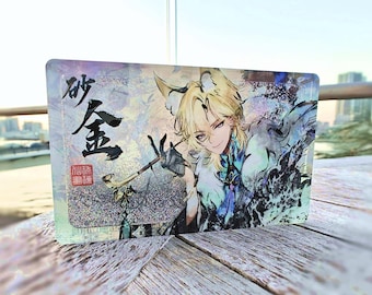 May include: A holographic card featuring a character with blonde hair and blue eyes. The character is wearing a white and blue outfit and holding a staff. The card has Chinese characters on it that read "Xiao" and "Gold".