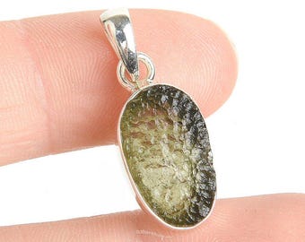 May include: A silver pendant with a green aventurine stone. The stone is oval shaped and has a textured surface.