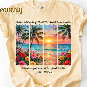 May include: Cream-colored t-shirt featuring a vibrant beach scene with palm trees, flowers, and a sunset. The text "This is the day that the Lord has made, let us rejoice and be glad in it. Psalm 118:24" is printed on the front.