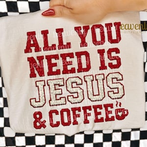 May include: Cream t-shirt with the text "ALL YOU NEED IS JESUS & COFFEE" in red and white lettering. The shirt is held up against a black and white checkered background.