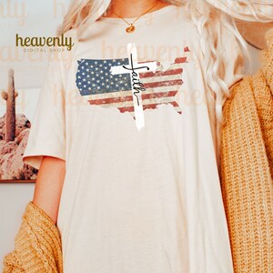 May include: A white t-shirt featuring a distressed American flag design and a white cross with the word "Faith" written on it.
