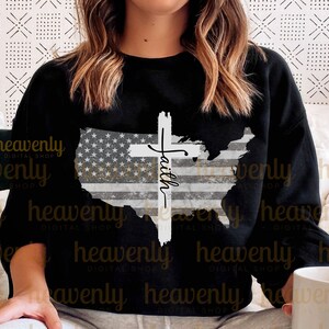 May include: Black sweatshirt featuring a distressed American flag design and a white cross with the word "Faith" written on it.