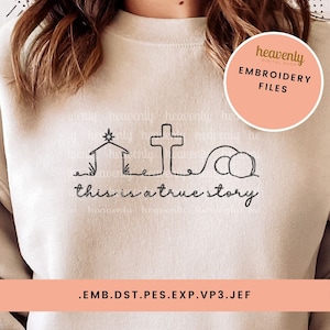 May include: A black and white embroidery design of a nativity scene, a cross, and two stones with the text "this is a true story". The design is on a beige sweatshirt. The design is available in embroidery file formats: EMB, DST, PES, EXP, VP3, and JEF.