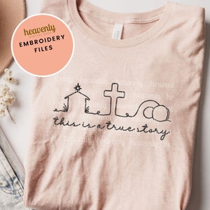 May include: A pink t-shirt with a black line drawing of a nativity scene and the text "this is a true story".