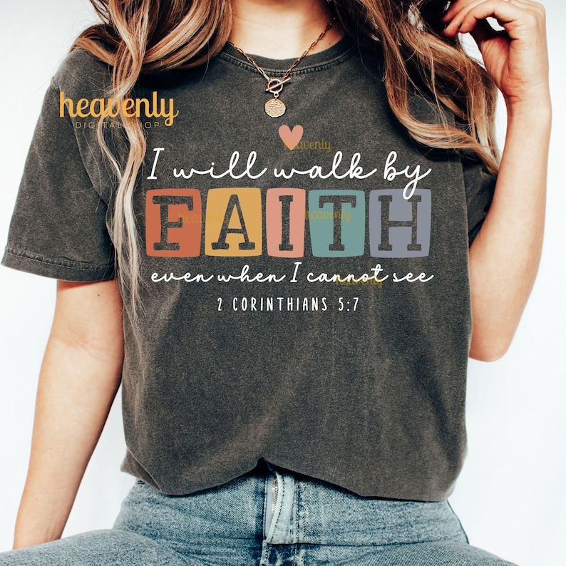 May include: A dark gray t-shirt with a colorful graphic that reads "I will walk by FAITH even when I cannot see 2 Corinthians 5:7".