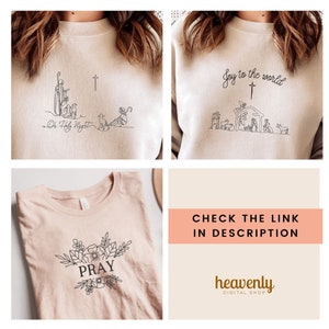 May include: Three different designs for a Christmas-themed sweatshirt. The first design features a nativity scene with the text "Joy to the world". The second design features a shepherd and sheep with the text "O Holy Night". The third design features a floral wreath with the text "PRAY".