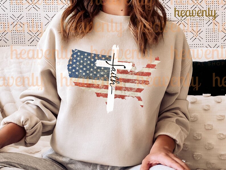 May include: A beige sweatshirt featuring a distressed American flag design and a white cross with the word "Faith" written on it.
