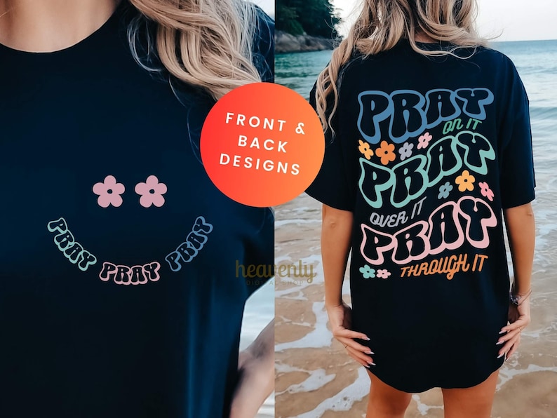 May include: Black t-shirt with front and back designs. The front features a smiley face made of flowers and the word "PRAY". The back has the words "PRAY on it, over it, through it" with flower accents.