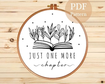 May include: Black and white embroidery pattern featuring a book with plants growing from it and the text "Just One More Chapter".