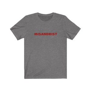 May include: A heather grey t-shirt with the word "MISANDRIST" printed in red on the front.