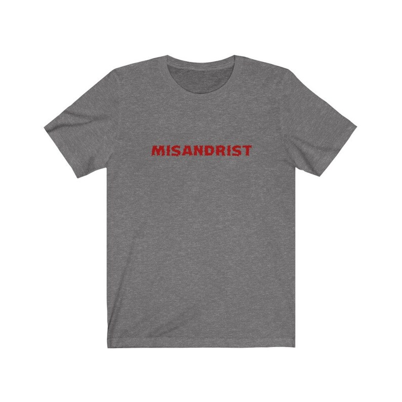 May include: A heather grey t-shirt with the word "MISANDRIST" printed in red on the front.