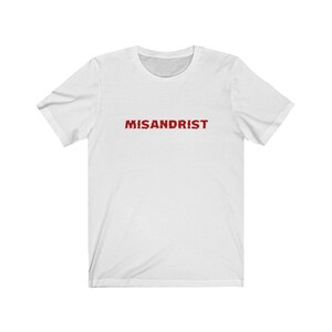 May include: White t-shirt with the word "MISANDRIST" printed in red on the front.