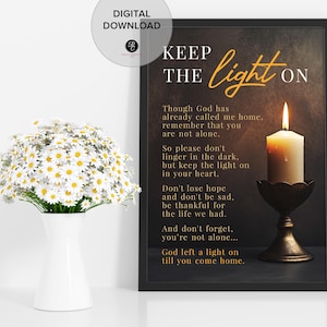 May include: A framed print with the text "KEEP THE LIGHT ON" and a lit candle. The print is black with gold lettering and a dark background. A vase of daisies is in the foreground.