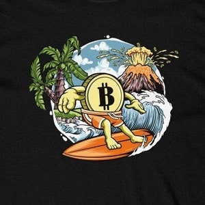 May include: A black t-shirt with a cartoon illustration of a Bitcoin coin surfing on a wave. The coin has a face and arms and is wearing blue shorts. The background includes a palm tree, a volcano, and blue water.