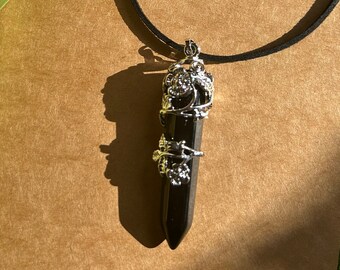Crystal Obsidian pendant necklace in silver casing on a leather strand.