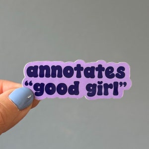 May include: Purple sticker with the text "annotates "good girl"" in dark blue lettering.