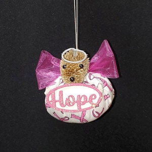 The Hope Angel Teasel Ornament is designed to encourage anyone impacted by Breast Cancer. Ten Dollars/ornament will be donated to charity.