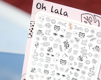 May include: A sheet of white sticker paper with black and white illustrations of various designs, including tigers, hearts, flowers, rainbows, and the text "Oh Lala" and "Why Not".