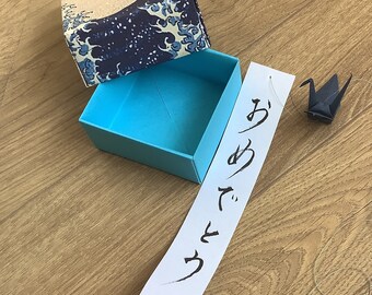 Vintage box greeting, origami crane mobile and note with congratulation in Japanese