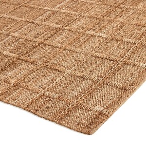 May include: A natural fiber rug with a woven pattern in a light brown color.