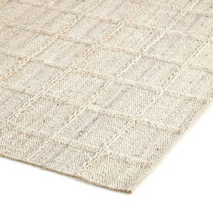 May include: A natural fiber rug with a woven diamond pattern in a light beige color.