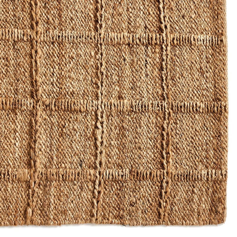 May include: A natural fiber rug with a woven, textured pattern in a light brown color.