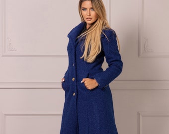May include: A long, blue coat with a collar and gold buttons. The coat is made of a textured fabric and has a slightly flared silhouette.