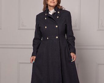 May include: A long, dark blue coat with a double-breasted closure and gold buttons. The coat has a high collar and a fitted waist.