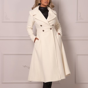 May include: A white double-breasted coat with a long, flowing skirt. The coat has a high collar and is belted at the waist.