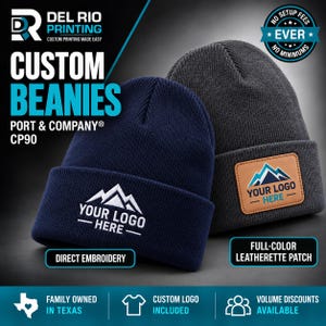 May include: Two Port & Company CP90 beanies. The navy blue beanie features white direct embroidery of a mountain graphic and the text YOUR LOGO HERE. The charcoal gray beanie features a tan leatherette patch with a mountain graphic.