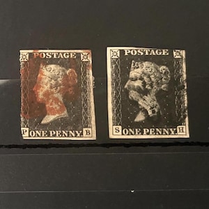 May include: Two black and white postage stamps featuring the profile of Queen Victoria. The left stamp has a red ink mark and the letters P and B in the corners. The right stamp has the letters S and H in the corners. Both stamps read POSTAGE ONE PENNY.