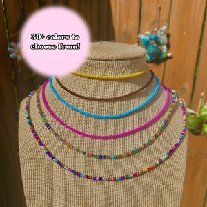 May include: A set of three ceramic mugs with a speckled, matte finish. The mugs are in shades of cream, light gray, and dark gray. Each mug has a simple, minimalist design, perfect for coffee or tea.