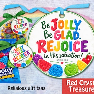 May include: A round white gift tag featuring the colorful text Be JOLLY. Be GLAD. REJOICE in His salvation! Isaiah 25:9, decorated with illustrations of fruit-shaped candies. Two bags of Jolly Rancher gummies are attached with green ribbons.