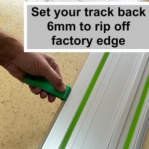 May include: A hand holding a green tool to adjust a silver track with green tape. The text "Set your track back 6mm to rip off factory edge" is visible in the image.