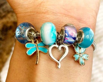 Silver Charm Bracelet with Blue Glass Beads, Dragonfly, Heart & Flower – Handmade Custom Bracelet